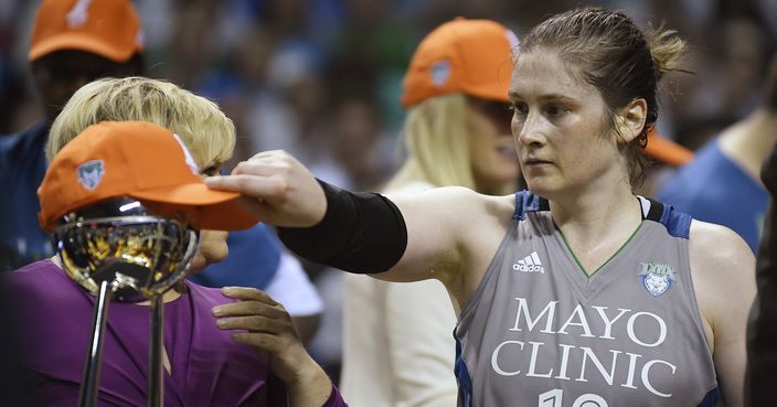 Minnesota Lynx guard Lindsay Whalen (13) puts her championship hat on the WNBA trophy after her team's 85-76 victory over the Los Angeles Sparks in Game 5 of the WNBA basketball finals, Wednesday, Oct. 4, 2017, in Minneapolis. (Aaron Lavinsky/Star Tribune via AP)