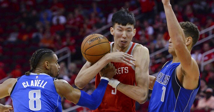 Houston Rockets center Zhou Qi (9) loses the ball as he is defended by Dallas Mavericks Gian Clavell (8) and Dennis Smith Jr. (1) in the second half of an NBA basketball game Saturday, Oct. 21, 2017, in Houston. (AP Photo/George Bridges)