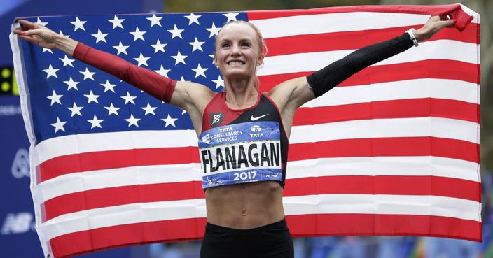 Shalane Flanagan of the United States poses for pictures after crossing the finish line first in the women's division of the New York City Marathon in New York, Sunday, Nov. 5, 2017. (AP Photo/Seth Wenig)