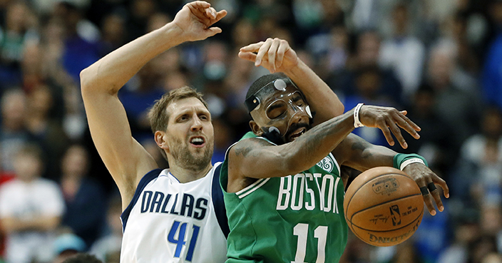 Boston Celtics guard Kyrie Irving (11) intercepts a pass intended for Dallas Mavericks' Dirk Nowitzki (41) of Germany in the second half of an NBA basketball game, Monday, Nov. 20, 2017, in Dallas. The Celtics won in overtime, 110-102. (AP Photo/Tony Gutierrez)