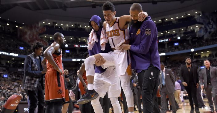 Phoenix Suns guard Devin Booker (1) is carried off by teammates during the second half of an NBA basketball game against the Toronto Raptors on Tuesday, Dec. 5, 2017, in Toronto. (Nathan Denette/The Canadian Press via AP)