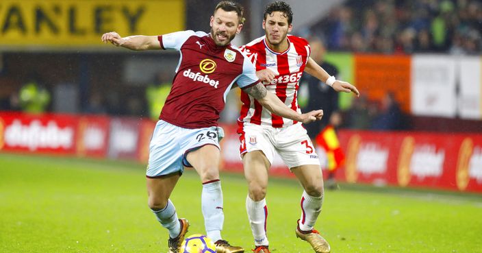 Burnley's Phil Bardsley, left, and Stoke City's Ramadan Sobhi vie for the ball during their English Premier League soccer match Burnley versus Stoke City at Turf Moor, Burnley, England, Tuesday, Dec. 12 2017. (Martin Rickett/PA via AP)