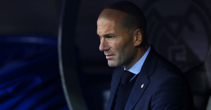 Real Madrid coach Zinedine Zidane sits on the bench before the Spanish La Liga soccer match between Real Madrid and Barcelona at the Santiago Bernabeu stadium in Madrid, Spain, Saturday, Dec. 23, 2017. (AP Photo/Francisco Seco)