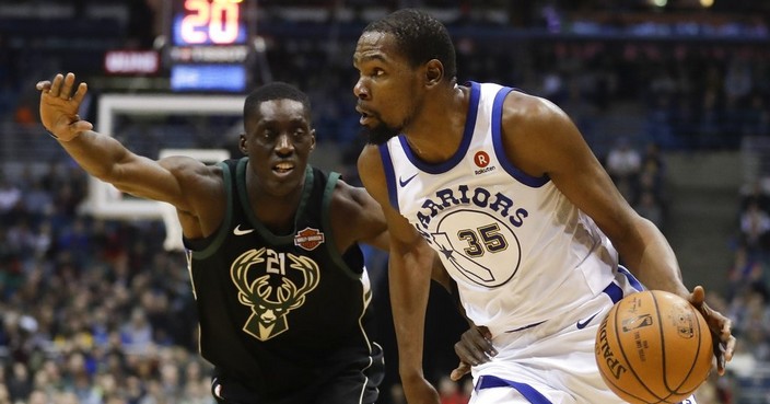 Golden State Warriors' Kevin Durant drives past Milwaukee Bucks' Tony Snell during the first half of an NBA basketball game Friday, Jan. 12, 2018, in Milwaukee. (AP Photo/Morry Gash)