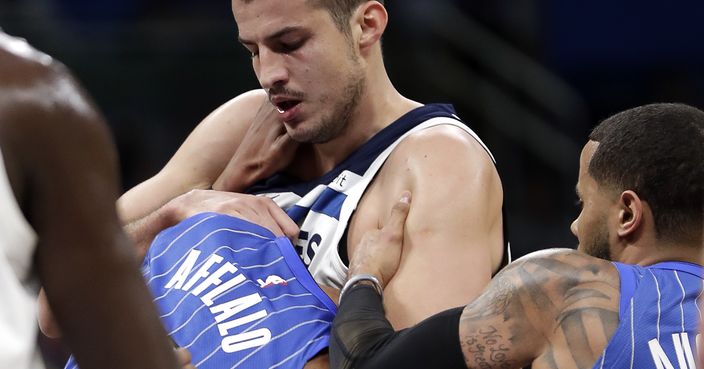Orlando Magic's Arron Afflalo, left, gets into a fight with Minnesota Timberwolves' Nemanja Bjelica, center, as D.J. Augustin, right, comes in to help break it up during the first half of an NBA basketball game, Tuesday, Jan. 16, 2018, in Orlando, Fla. Afflalo and Bjelica were ejected from the game. (AP Photo/John Raoux)