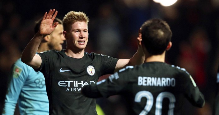 Manchester City's Kevin De Bruyne, left, celebrates scoring his side's third goal of the game during the English League Cup semi final, second leg match against Bristol City at Ashton Gate, Bristol, England, Tuesday, Jan. 23, 2018. (Nick Potts/PA via AP)