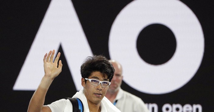South Korea's Hyeon Chung waves as he leaves Rod Laver Arena after retiring injured from his semifinal against Switzerland's Roger Federer at the Australian Open tennis championships in Melbourne, Australia, Friday, Jan. 26, 2018. (AP Photo/Dita Alangkara)