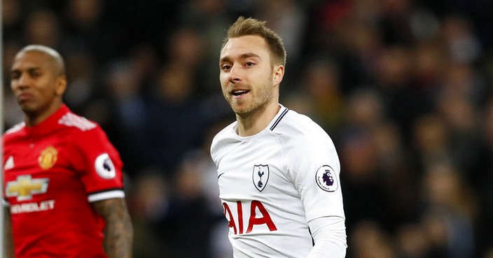 Tottenham's Christian Eriksen,right, smiles after scoring the opening goal during the English Premier League soccer match between Tottenham Hotspur and Manchester United at Wembley stadium in London, England, Wednesday, Jan. 31, 2018. (AP Photo/Kirsty Wigglesworth)