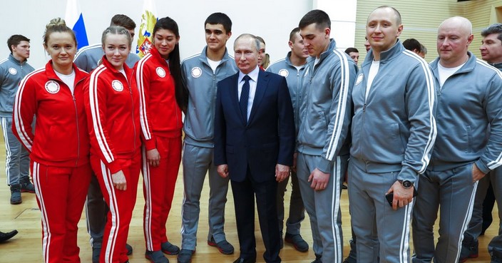 Russian President Vladimir Putin, center, poses for a photo with Russian athletes who will take part in the upcoming 2018 Pyeongchang Winter Olympic Games in South Korea, at the Novo-Ogaryovo residence outside in Moscow, Russia, Wednesday, Jan. 31, 2018. (Grigory Dukor/Pool Photo via AP)