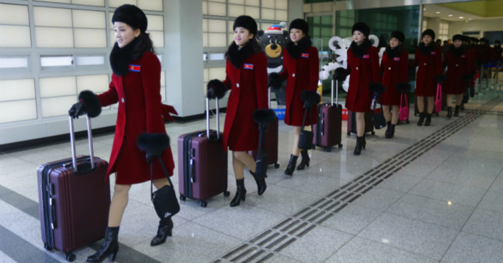 North Korean cheering squads arrive at the Korean-transit office near the Demilitarized Zone in Paju, South Korea, Wednesday, Feb. 7, 2018. A North Korean delegation, including members of a state-trained cheering group, arrived in South Korea on Wednesday for the Pyeongchang Winter Olympics. (AP Photo/Ahn Young-joon. Pool)
