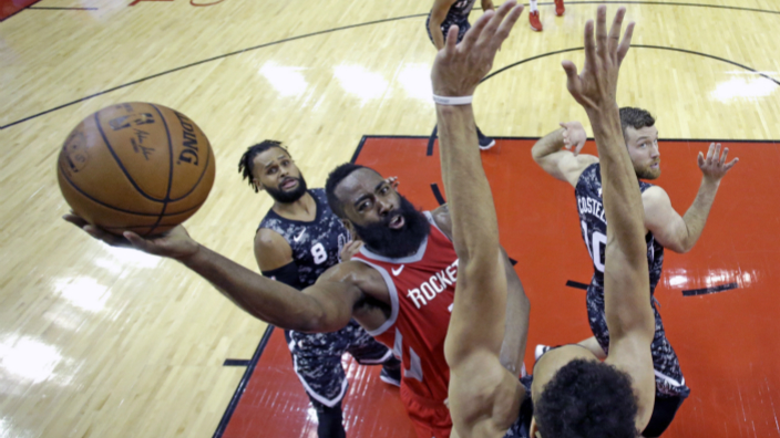 Houston Rockets' James Harden, center, shoots as San Antonio Spurs' Derrick White, bottom, defends during the second half of an NBA basketball game Monday, March 12, 2018, in Houston. The Rockets won 109-93. (AP Photo/David J. Phillip)