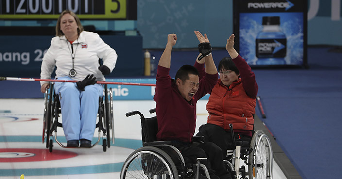 China's Wang Meng, right and Liu Wei celebrates a good throw near Norway's Sissel Loechen at left during the Wheelchair Curling gold medal match for the 2018 Winter Paralympics at the Gangneung Curling Centre in Gangneung, South Korea, Saturday, March 17, 2018.(AP Photo/Ng Han Guan)