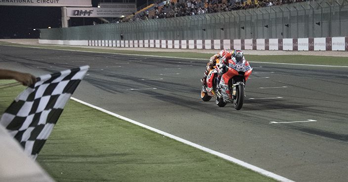 DOHA, QATAR - MARCH 18:  Andrea Dovizioso of Italy and Ducati Team cuts the finish lane in front of Marc Marquez of Spain and Repsol Honda Team and celebrates the victory at the end of the MotoGP race during the MotoGP of Qatar - Race at Losail Circuit on March 18, 2018 in Doha, Qatar.  (Photo by Mirco Lazzari gp/Getty Images)