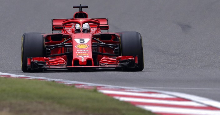 Ferrari driver Sebastian Vettel of Germany steers his car during the qualifying session for the Chinese Formula One Grand Prix at the Shanghai International Circuit in Shanghai, Saturday, April 14, 2018. Vettel took pole position for Sunday's race. (AP Photo/Andy Wong)