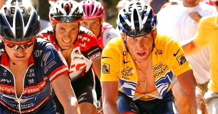 FILE - In this July 24, 2004, file pool photo, overall leader Lance Armstrong, right, of Austin, Texas, follows compatriot and teammate Floyd Landis, left, in the ascent of the La Croix Fry pass during the 17th stage of the Tour de France cycling race between Bourg-d'Oisans and Le Grand Bornand, French Alps. Armstrong, on Thursday, April 19, 2018, has reached a $5 million settlement with the federal government in a whistleblower lawsuit that could have sought $100 million in damages from the cyclist who was stripped of his record seven Tour de France victories after admitting he used performance-enhancing drugs throughout much of his career.  (Bernard Papon/Pool Photo via AP, File)