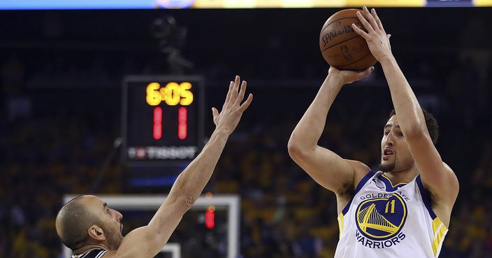 Golden State Warriors' Klay Thompson, right, shoots against San Antonio Spurs' Manu Ginobili (20) during the first quarter in Game 5 of a first-round NBA basketball playoff series Tuesday, April 24, 2018, in Oakland, Calif. (AP Photo/Ben Margot)