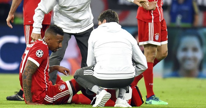Bayern's Jerome Boateng is attend to by team doctor Hans-Wilhelm Mueller-Wohlfahrt during the soccer Champions League first leg semifinal soccer match between FC Bayern Munich and Real Madrid in Munich, southern Germany, Wednesday, April 25, 2018. (Sven Hoppe/dpa via AP)