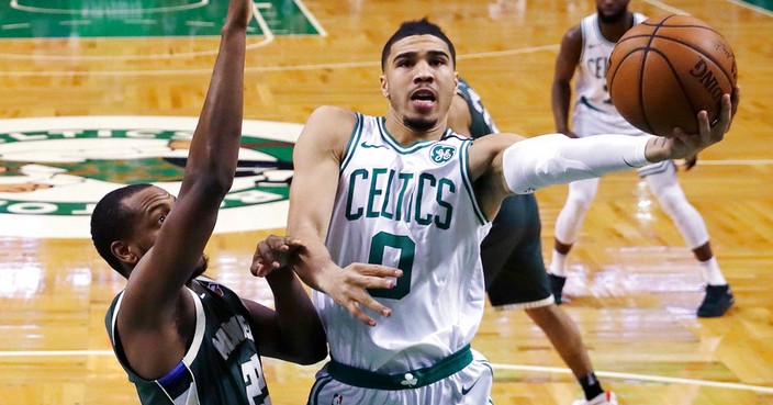 Boston Celtics forward Jayson Tatum (0) drives to the basket against Milwaukee Bucks forward Khris Middleton, left, during the first quarter of Game 7 of an NBA basketball first-round playoff series in Boston, Saturday, April 28, 2018. (AP Photo/Charles Krupa)