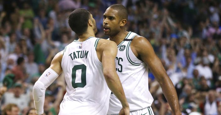 Boston Celtics forwards Jayson Tatum (0) and Al Horford, right, chest-bump to celebrate in the fourth quarter of Game 2 of the team's NBA basketball second-round playoff series against the Philadelphia 76ers, Thursday, May 3, 2018, in Boston. The Celtics won 108-103. (AP Photo/Elise Amendola)