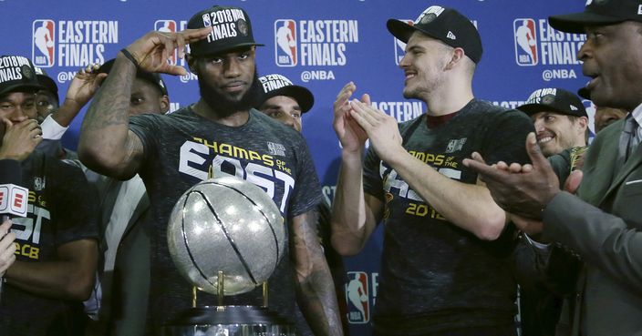 Cleveland Cavaliers forward LeBron James salutes after his team was presented the trophy for beating the Boston Celtics 87-79 in Game 7 of the NBA basketball Eastern Conference finals, Sunday, May 27, 2018, in Boston. (AP Photo/Elise Amendola)