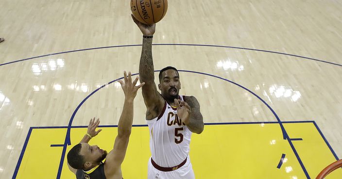 Cleveland Cavaliers guard J.R. Smith (5) shoots against Golden State Warriors guard Stephen Curry (30) and center JaVale McGee during the first half of Game 2 of basketball's NBA Finals in Oakland, Calif., Sunday, June 3, 2018. (AP Photo/Marcio Jose Sanchez, Pool)