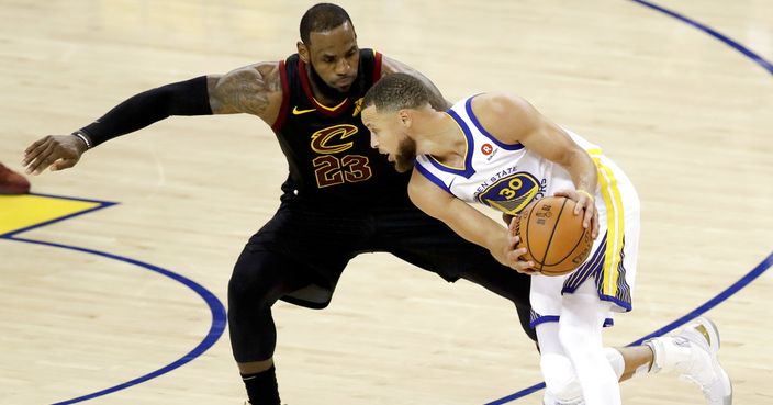 Cleveland Cavaliers forward LeBron James, left, defends Golden State Warriors guard Stephen Curry during the second half of Game 1 of basketball's NBA Finals in Oakland, Calif., Thursday, May 31, 2018. (AP Photo/Marcio Jose Sanchez)
