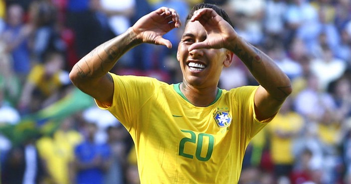 Brazil's Roberto Firmino, right, celebrates with team mate Neymar after scoring his side's second goal during the friendly soccer match between Brazil and Croatia at Anfield Stadium in Liverpool, England, Sunday, June 3, 2018. (AP Photo/Dave Thompson)