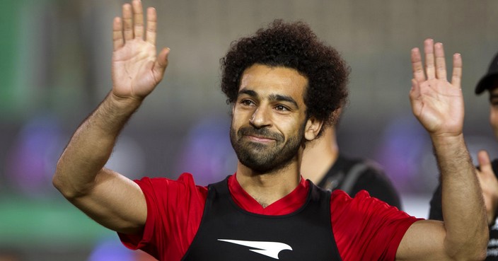 Egyptian national team soccer player and Liverpool's star striker Mohammed Salah smiles as he greets fans during the final training of the national team at Cairo Stadium in Cairo, Egypt, Saturday, June 9, 2018. About 2,000 fans gathered at Cairo's main stadium on Saturday to watch Egypt's last home practice before the Pharaohs fly to their World Cup base in Grozny, Chechnya. (AP Photo/Amr Nabil)