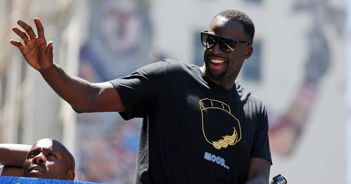 Golden State Warriors' Draymond Green waves to fans during the team's NBA basketball championship parade, Tuesday, June 12, 2018, in Oakland, Calif. (AP Photo/Tony Avelar)