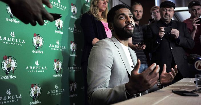 Boston Celtics' Kyrie Irving, center, takes questions from reporters, Tuesday, June 12, 2018, during a news conference, in Boston. Irving spoke about the upcoming film 