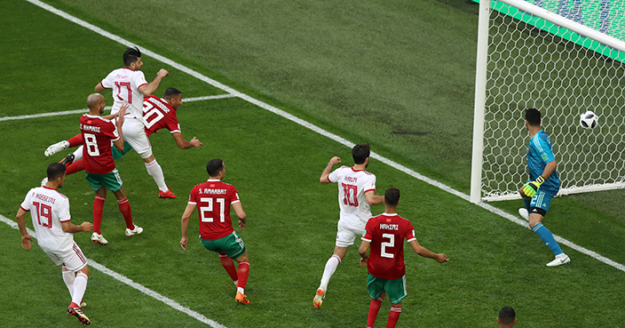 SAINT PETERSBURG, RUSSIA - JUNE 15:  Aziz Bouhaddouz of Morocco scores an own goal for Iran's first goal during the 2018 FIFA World Cup Russia group B match between Morocco and Iran at Saint Petersburg Stadium on June 15, 2018 in Saint Petersburg, Russia.  (Photo by Francois Nel/Getty Images)