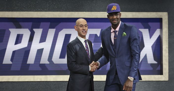 Arizona's Deandre Ayton, right, poses with NBA Commissioner Adam Silver after he was picked first overall by the Phoenix Suns during the NBA basketball draft in New York, Thursday, June 21, 2018. (AP Photo/Kevin Hagen)