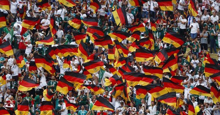 Fans wave German flags before the start of the group F match between Germany and Mexico at the 2018 soccer World Cup in the Luzhniki Stadium in Moscow, Russia, Sunday, June 17, 2018. (AP Photo/Eduardo Verdugo)