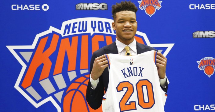 New York Knicks first round NBA Draft pick, Kevin Knox, poses with his jersey at the teams training facility Friday, June 22, 2018, in Tarrytown, N.Y.  (AP Photo/Kevin Hagen)