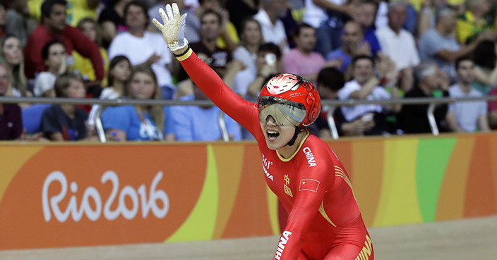 Jinjie Gong of China celebrates after winning gold with teammate Tianshi Zhong in the Women's team sprint finals at the Rio Olympic Velodrome during the 2016 Summer Olympics in Rio de Janeiro, Brazil, Friday, Aug. 12, 2016. (AP Photo/Pavel Golovkin)