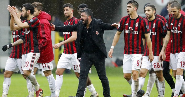FILE - In this Sunday, March 18, 2018 file photo, AC Milan coach Gennaro Gattuso celebrates with his players after winning the Serie A soccer match between AC Milan and Chievo Verona at the San Siro stadium in Milan, Italy. UEFA has on Wednesday, June 27, 2018 given AC Milan a one-year Europa League ban for overspending on player transfer and wages. Milan last year spent more than 200 million euros (then nearly $250 million) on new players amid questions over the financial stability of the Chinese-led consortium that purchased the Italian club from Silvio Berlusconi for $800 million in April 2017. (AP Photo/Antonio Calanni, file)