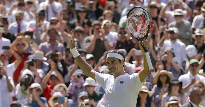 Roger Federer of Switzerland salutes spectators after defeating Serbia's Dusan Lajovic, in their Men's Singles first round match at the Wimbledon Tennis Championships in London, Monday July 2, 2018. (AP Photo/Tim Ireland)