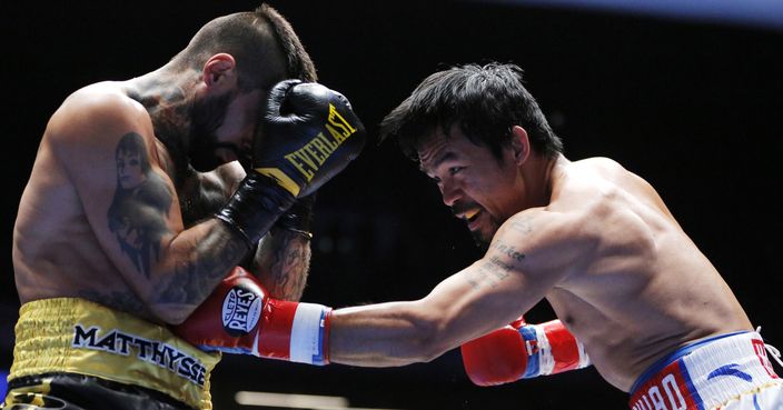 Manny Pacquiao, right, of the Philippines, lands a punch at Lucas Matthysse of Argentina during their WBA World welterweight title bout in Kuala Lumpur, Malaysia, Sunday, July 15, 2018. Pacquiao clinched his 60th victory with a seventh-round knockout Sunday of Matthysse, his first stoppage in nine years. (AP Photo/Yam G-Jun)