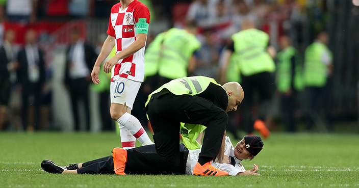 MOSCOW, RUSSIA - JULY 15:  Stewards drag a pitch invader off the pitch during the 2018 FIFA World Cup Final between France and Croatia at Luzhniki Stadium on July 15, 2018 in Moscow, Russia.  (Photo by Clive Rose/Getty Images)