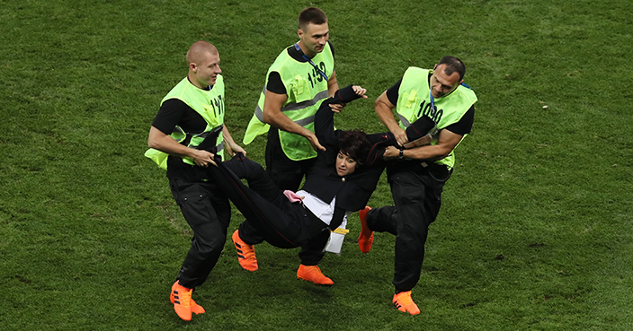 MOSCOW, RUSSIA - JULY 15:  Stewards drag a pitch invader off the pitch during the 2018 FIFA World Cup Final between France and Croatia at Luzhniki Stadium on July 15, 2018 in Moscow, Russia.  (Photo by Kevin C. Cox/Getty Images)