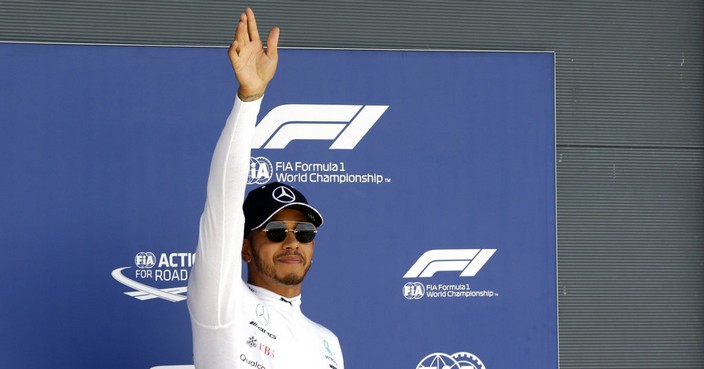 Mercedes driver Lewis Hamilton of Britain waves to spectators after getting the pole position in the qualifying session for the British Formula One Grand Prix, at the Silverstone racetrack, Silverstone, England, Saturday, July 7, 2018. The British Formula One Grand Prix will be held on Sunday. (AP Photo/Luca Bruno)