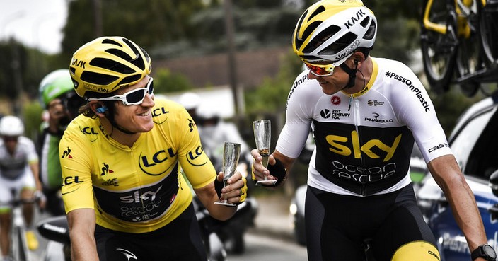 Britain's Geraint Thomas, left, wearing the overall leader's yellow jersey and Britain's Christopher Froome toast with Champagne during the 21st and last stage of the 105th edition of the Tour de France cycling race between Houilles and Paris Champs-Elysees, Sunday, July 29, 2018. (Marco Bertorello, Pool via AP)