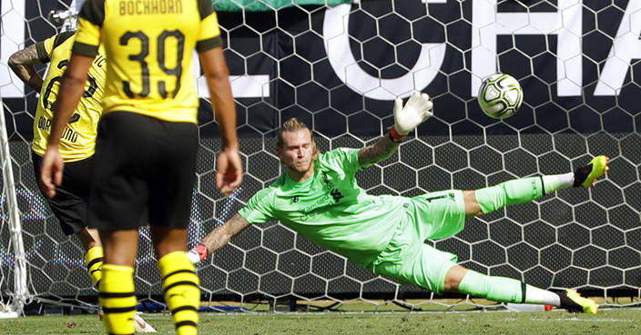 Liverpool's Loris Karius (1) can't stop a penalty kick by Borussia Dortmund's Christian Pulisic (22) during the second half of an International Champions Cup tournament soccer match in Charlotte, N.C., Sunday, July 22, 2018. (AP Photo/Chuck Burton)