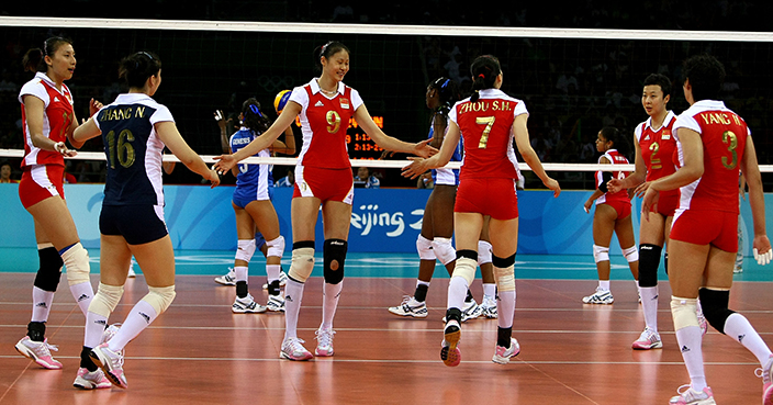BEIJING - AUGUST 09:  The China women's volleyball team celebrates winning their match 3-0 against Venezuela   at the Capital Indoor Stadium during Day 1 of the Beijing 2008 Olympic Games on August 9, 2008 in Beijing, China.  (Photo by Clive Rose/Getty Images)