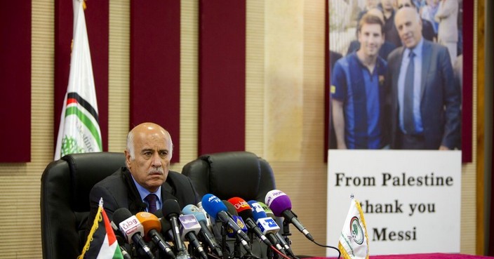 Head of the Palestinian Football Association Jibril Rajoub speaks aduring a press conference over Argentina's national football team's cancellation of a pre-World Cup friendly with Israel in Jerusalem, in the West Bank town of Ramallah , Wednesday, Jun. 6, 2018. Argentina has called off a World Cup warmup match against Israel following protests by pro-Palestinian groups.The background photo shows Fibril with Argentina 's superstar Lionel Messi. (AP Photo/Majdi Mohammed)