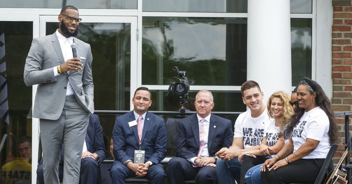 LeBron James gets a laugh from his mother, Gloria, right, and other officials at the opening ceremony for the I Promise School in Akron, Ohio, Monday, July 30, 2018. The I Promise School is supported by the The LeBron James Family Foundation and is run by the Akron Public Schools. (AP Photo/Phil Long)