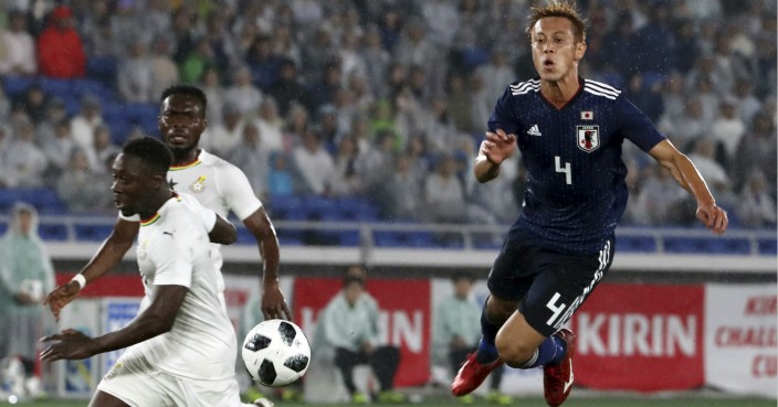 Japan’s Keisuke Honda, right, and Ghana’s Emmanuel Boateng, left, collide during a friendly soccer match between Japan and Ghana in Yokohama, Japan, Wednesday, May 30, 2018. (AP Photo/Eugene Hoshiko)