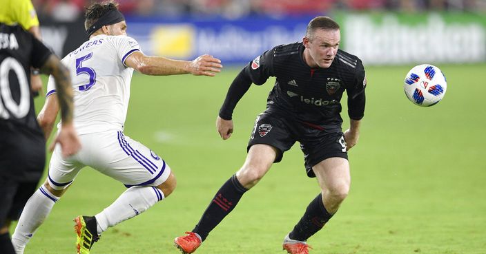 D.C. United forward Wayne Rooney, right, chases the ball against Orlando City midfielder Dillon Powers (5) during the second half of an MLS soccer match, Sunday, Aug. 12, 2018, in Washington. D.C. United won 3-2. (AP Photo/Nick Wass)