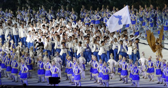 The combined Koreas march into Gelora Bung Karno Stadium under the 