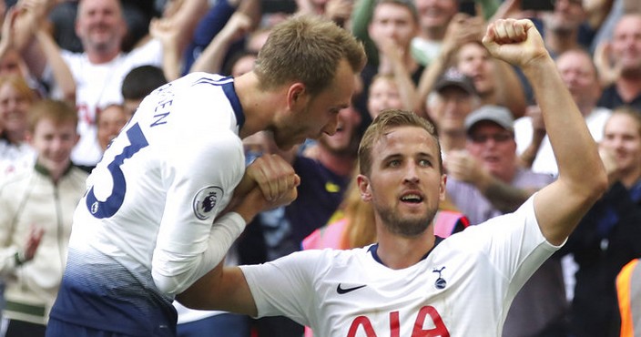 Tottenham Hotspur's Harry Kane, right, celebrates scoring his side's third goal of the game against Fulham with team-mate Christian Eriksen during the English Premier League soccer match at Wembley Stadium in London, Saturday Aug. 18, 2018. After 15 games and more than 1,000 minutes, Harry Kane has finally scored a Premier League goal. (Nick Potts/PA via AP)